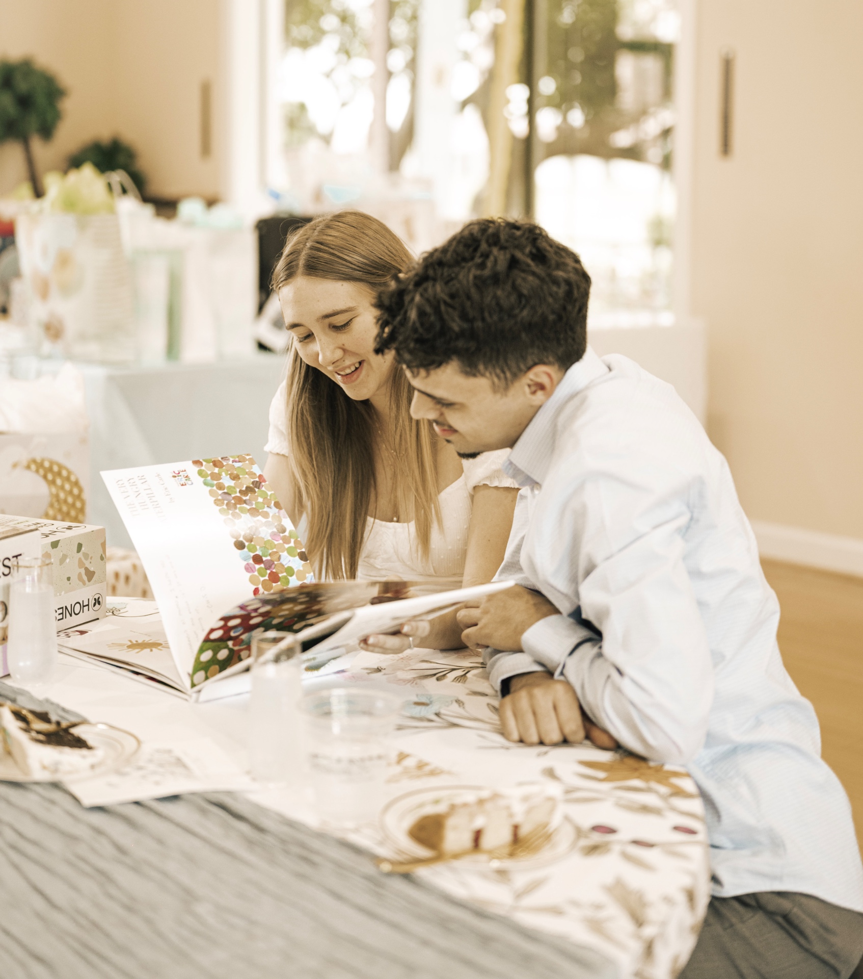 Couple reading a photo album together at a celebration table