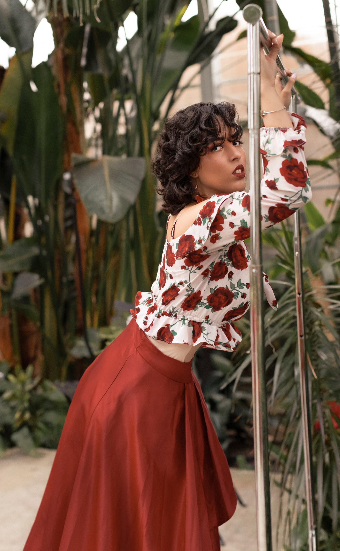 Fashion portrait in a floral look among tropical plants