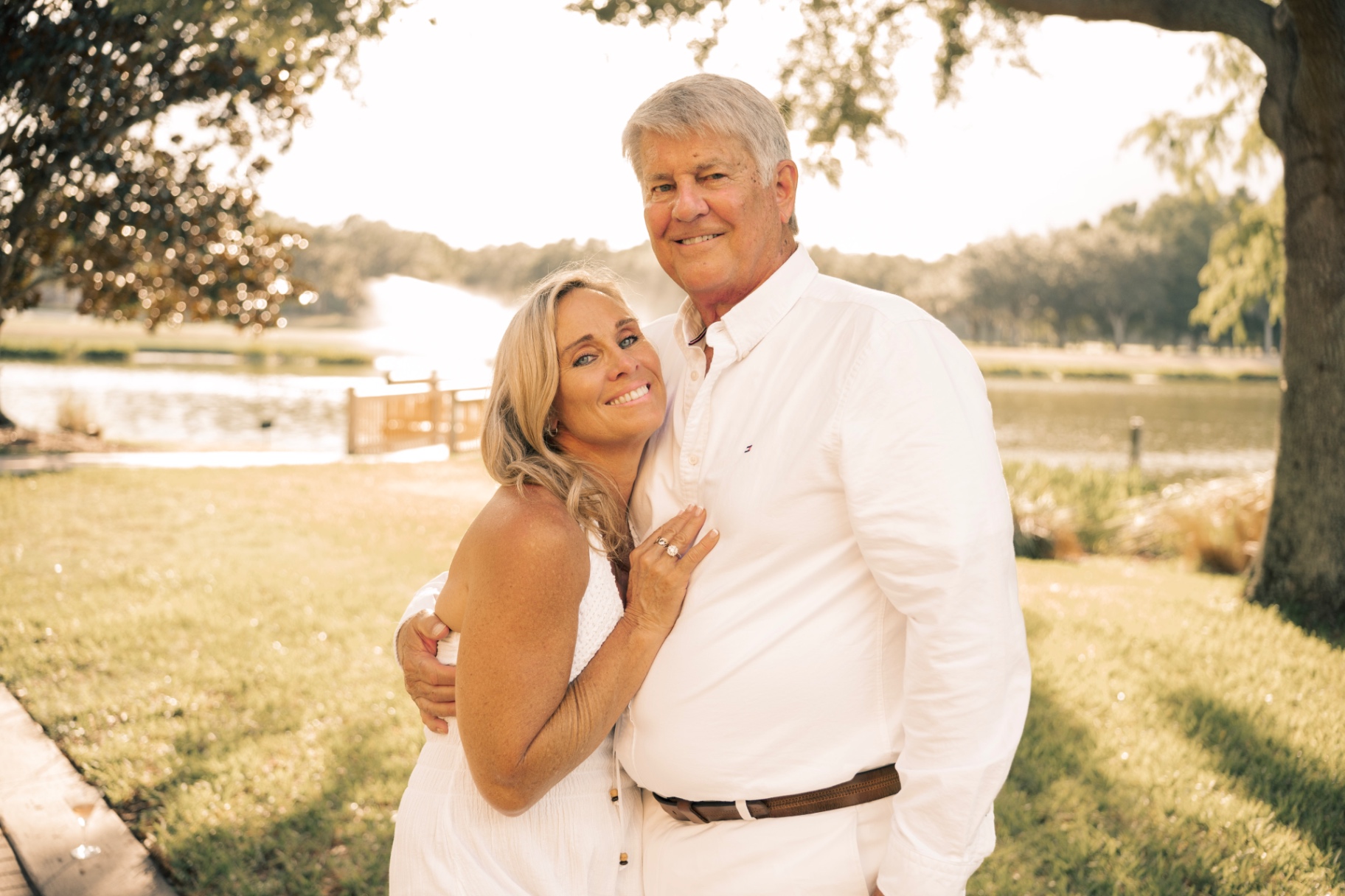 Couple embracing beside a lake in the evening light